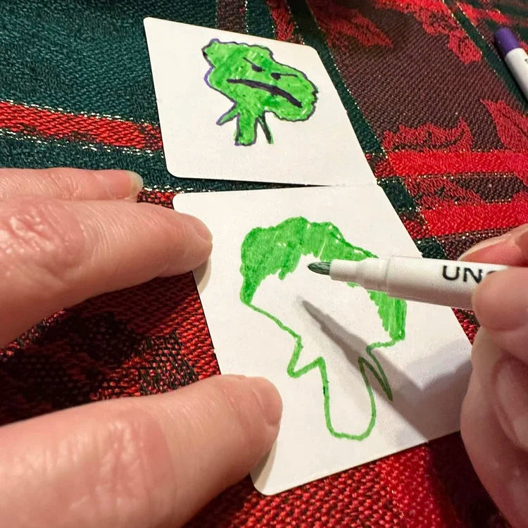 Hand drawing on the white matte surface of a MemoryMix blank card using a marker, showing smooth, smudge-resistant texture.